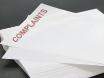 A photo of a stack of written complaints